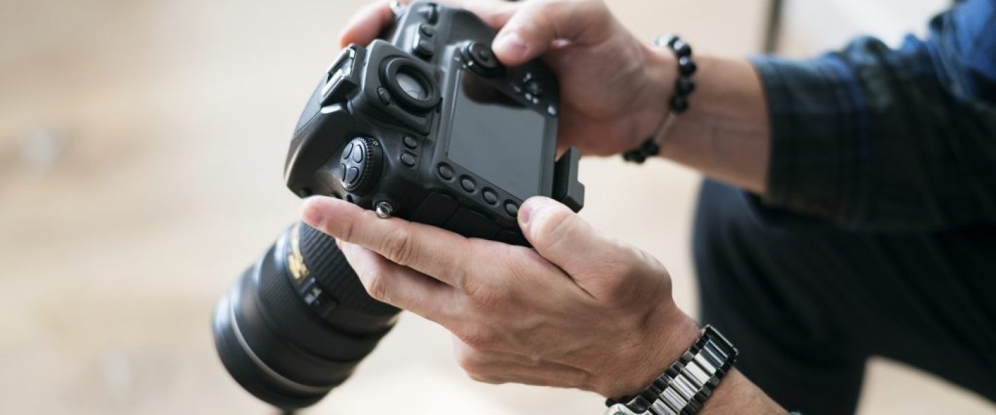 A man checking camera record